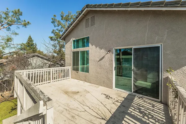 a view of house with yard and swimming pool