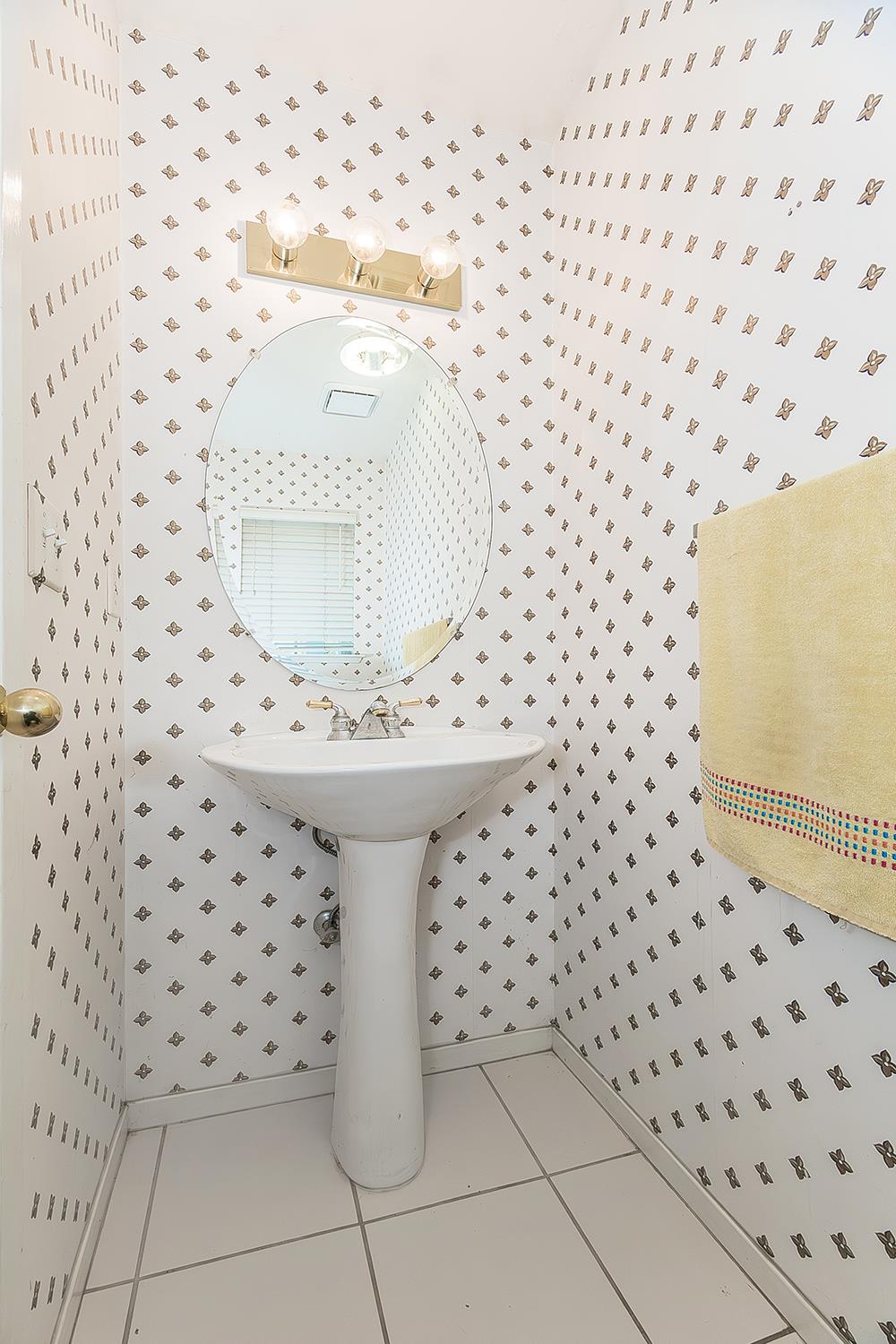 1322 Carson Avenue Clovis, CA 93611 - Photo 33 of 37 a bathroom with a sink a mirror and a shower