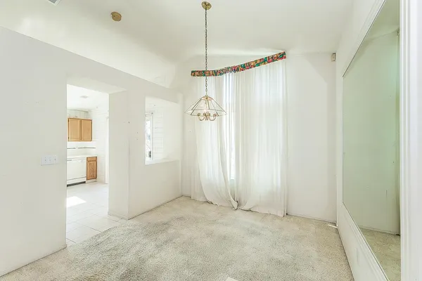 a view of a room with cabinet and a chandelier