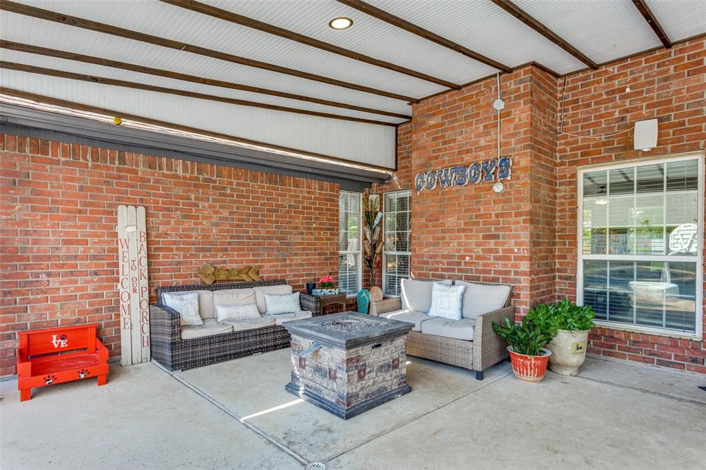 1228 Concho Drive Benbrook, TX 76126 - Photo 32 of 39 Covered outdoor living space featuring brick walls, a concrete floor, and a metal-paneled ceiling with recessed lighting