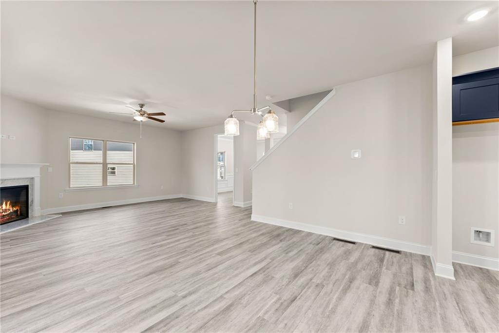657 Forest Way Cornelia, GA 30531 - Photo 15 of 54 a view of a livingroom with wooden floor and a ceiling fan