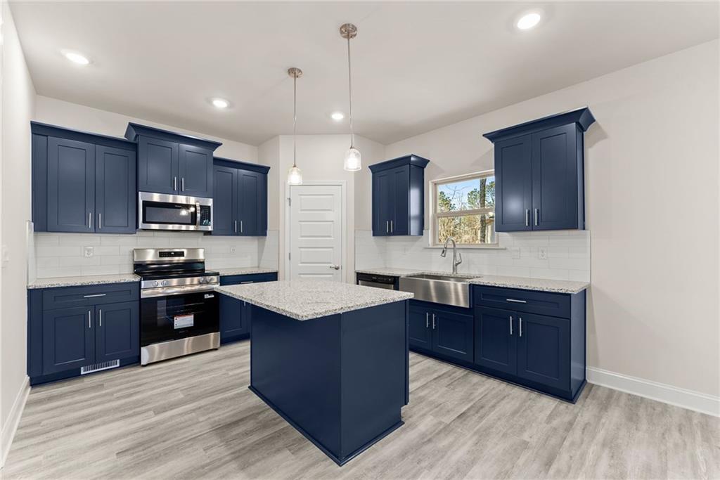 657 Forest Way Cornelia, GA 30531 - Photo 17 of 54 a kitchen with stainless steel appliances granite countertop wooden cabinets a stove top oven a sink and dishwasher