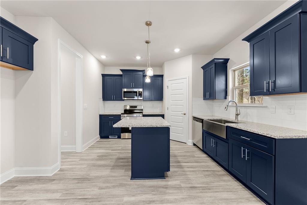657 Forest Way Cornelia, GA 30531 - Photo 18 of 54 a large kitchen with cabinets