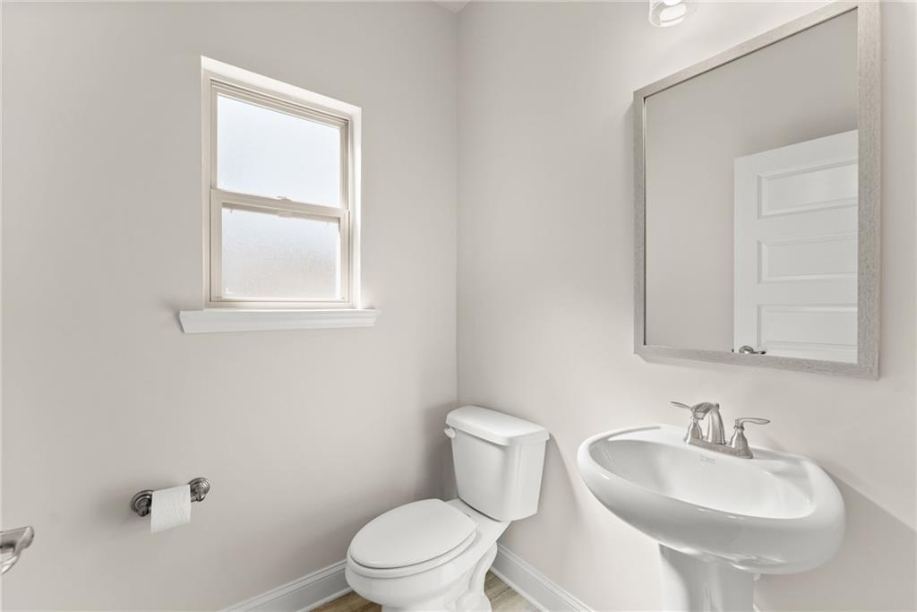 657 Forest Way Cornelia, GA 30531 - Photo 21 of 54 a white toilet sitting next to a bathroom sink