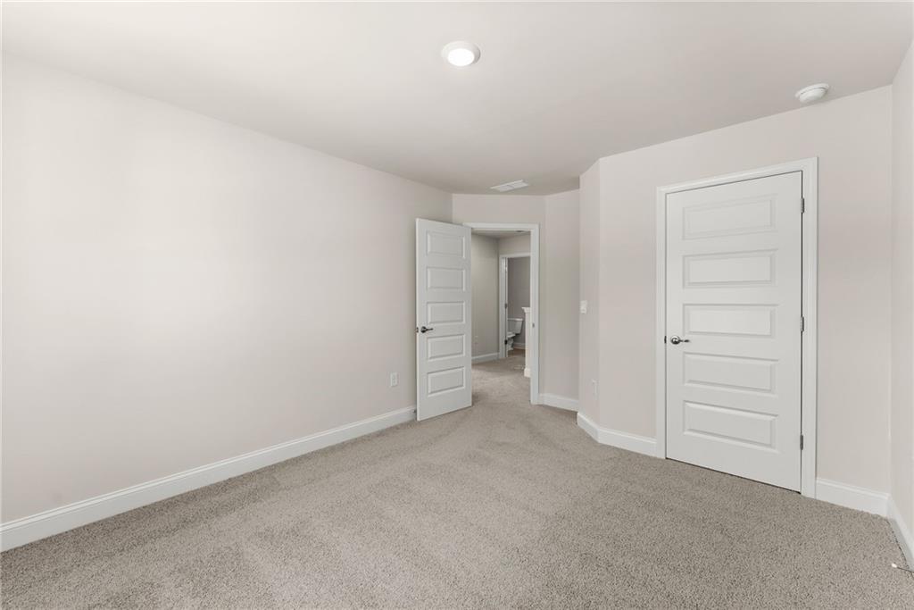 657 Forest Way Cornelia, GA 30531 - Photo 33 of 54 an empty room with a hallway and toilet