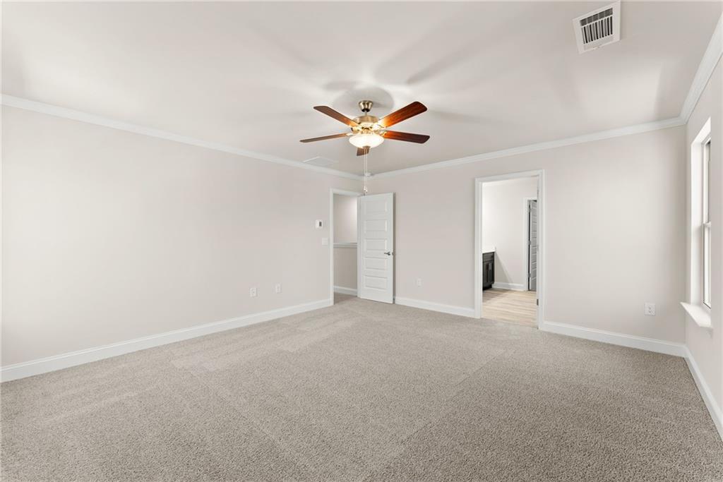 657 Forest Way Cornelia, GA 30531 - Photo 39 of 54 an empty room with a ceiling fan and a window