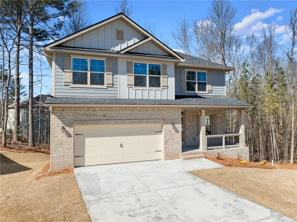 657 Forest Way Cornelia, GA 30531 - Photo 4 of 54 a front view of a house with a yard and garage