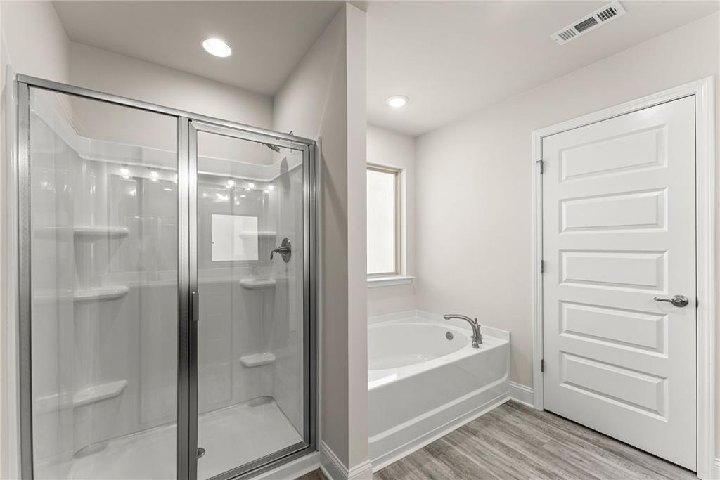 657 Forest Way Cornelia, GA 30531 - Photo 41 of 54 a bathroom with a bathtub and a shower