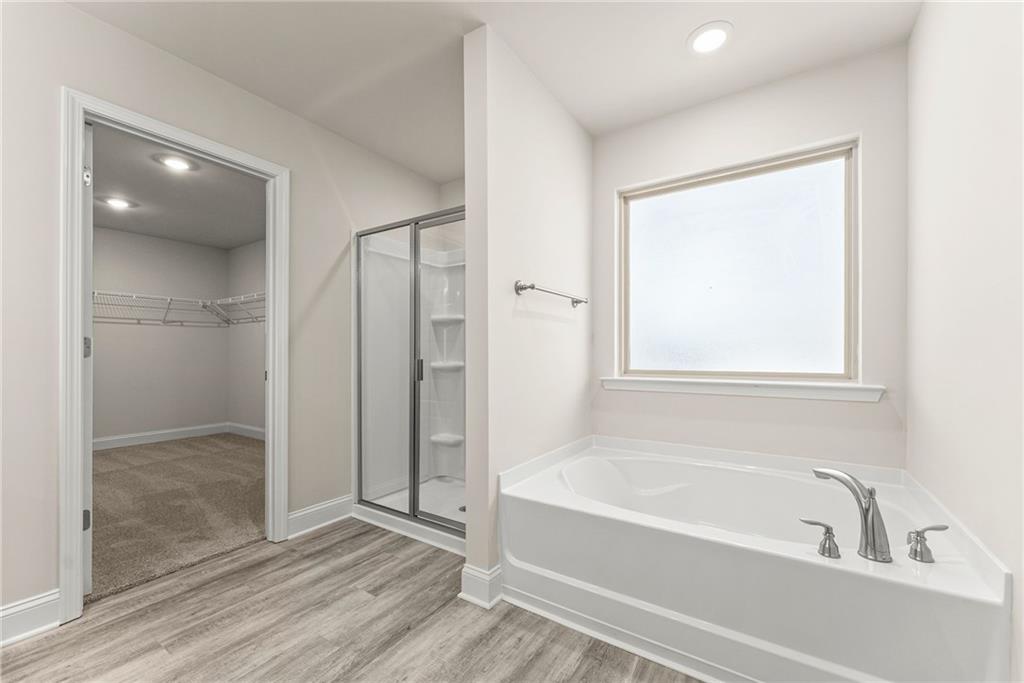 657 Forest Way Cornelia, GA 30531 - Photo 42 of 54 a bathroom with a bathtub and a shower
