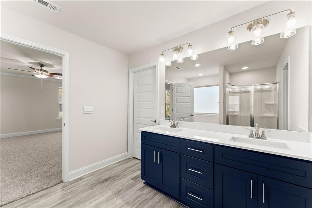 657 Forest Way Cornelia, GA 30531 - Photo 44 of 54 a bathroom with a double vanity sink and a mirror
