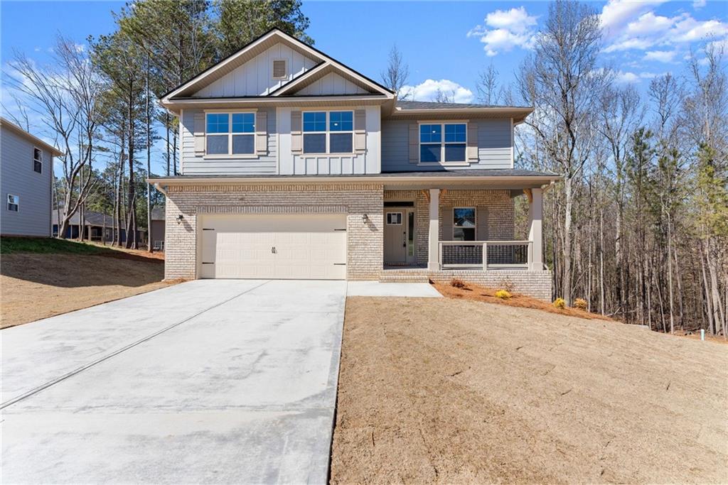657 Forest Way Cornelia, GA 30531 - Photo 5 of 54 a front view of a house with a yard and garage