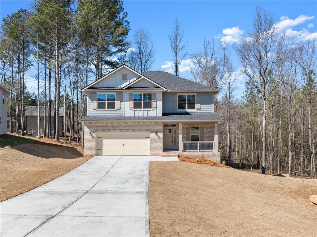 657 Forest Way Cornelia, GA 30531 - Photo 7 of 54 a front view of a house with a yard and garage