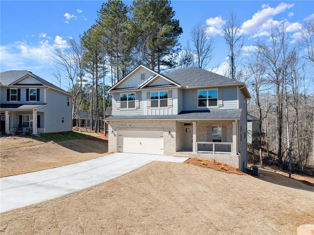 657 Forest Way Cornelia, GA 30531 - Photo 8 of 54 a front view of a house with a yard and garage