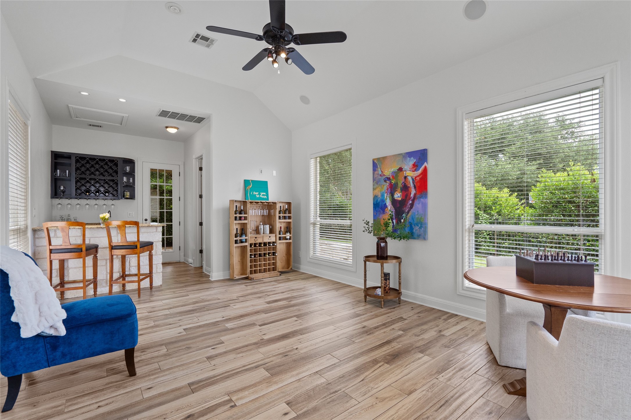 4313 Rio Robles Drive Austin, TX 78746 - Photo 17 of 40 A vibrant entertainment space with a built-in bar and ample natural light, ideal for gatherings.