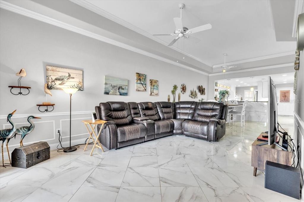 1260 Rio De Janeiro Avenue, Unit 102 Punta Gorda, FL 33983 - Photo 8 of 46 a living room with furniture and a chandelier