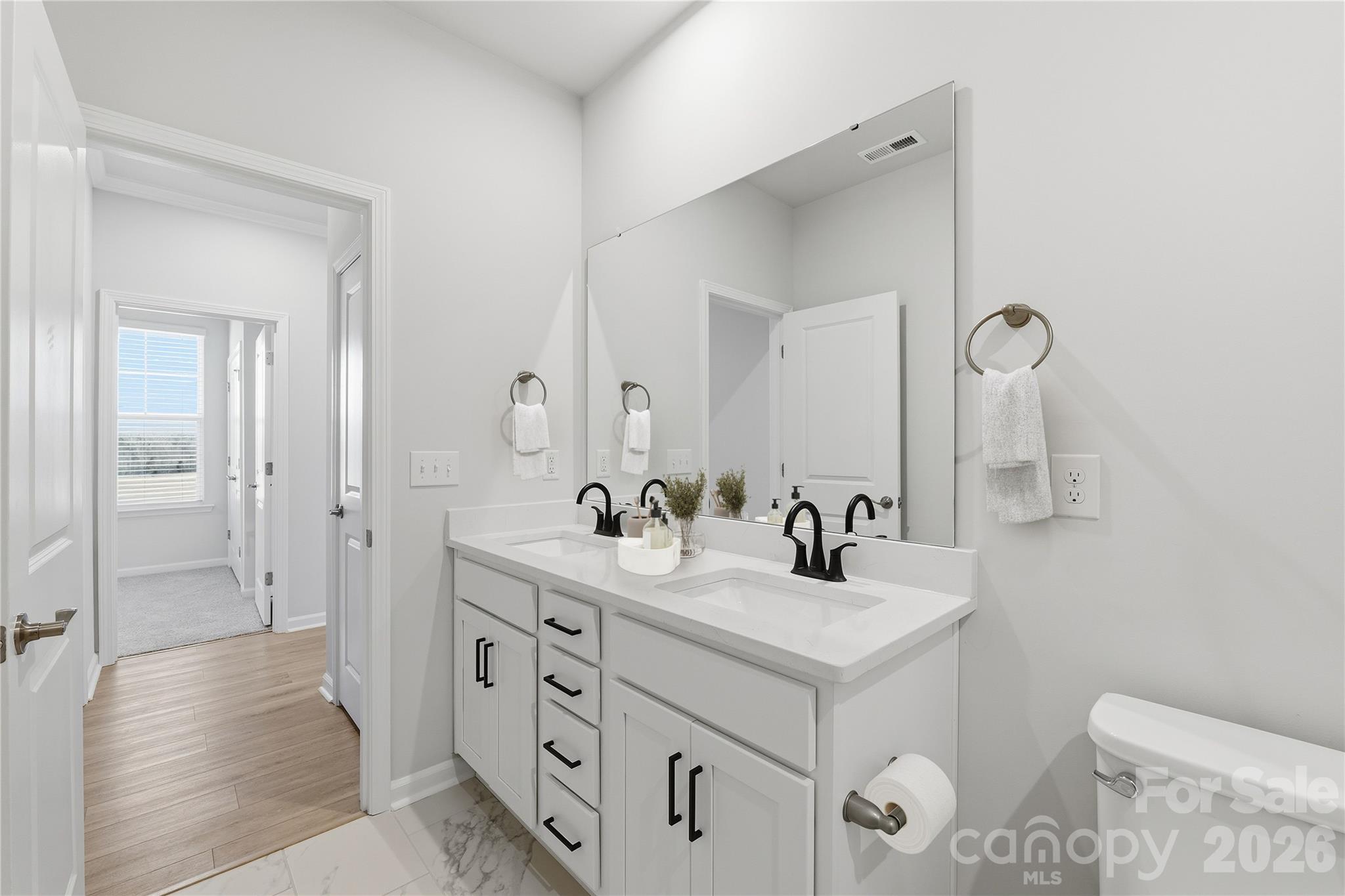 1028 Garfield Road Sherrills Ford, NC 28673 - Photo 17 of 37 a bathroom with a double vanity sink mirror and toilet