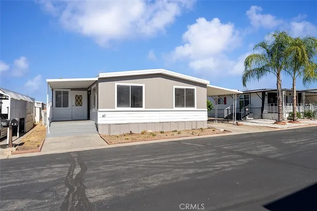 a front view of a house with a garden and yard
