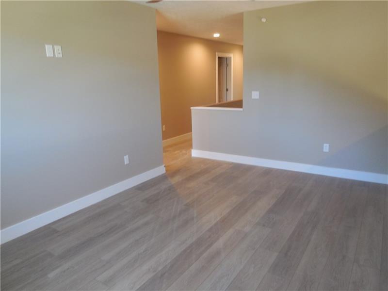 27 Pinehurst Place, Unit 27 Beaver, PA 15009 - Photo 12 of 19 an empty room with wooden floor and windows