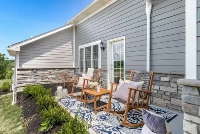 a backyard of a house with outdoor seating