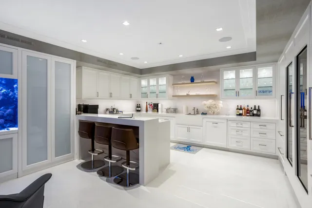 a kitchen with granite countertop a sink cabinets and window stainless steel appliances