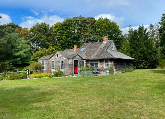 a front view of a house with garden