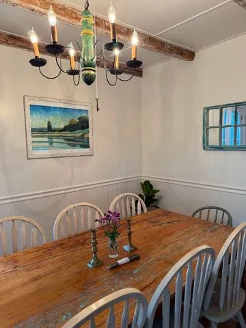 a living room with furniture a large window and a fireplace