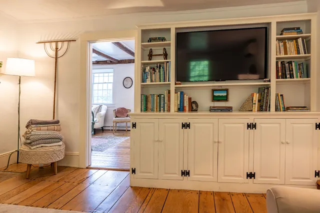 a large bedroom with a bed and large window