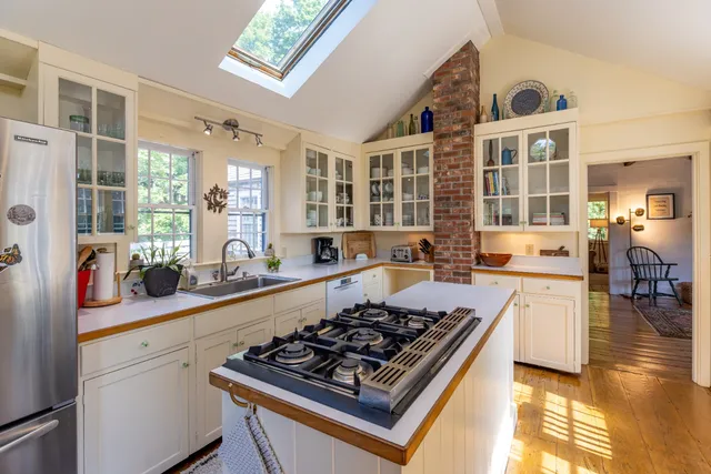 a kitchen with lots of counter top space and wooden floor