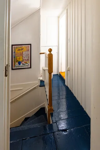 a view of a house with a big yard potted plants and large tree
