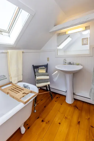 a en suite bathroom with a tub sink and window