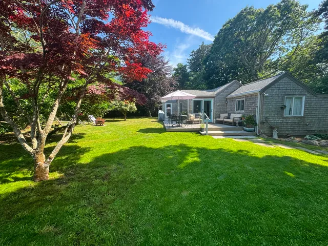 a view of a house with swimming pool and sitting area