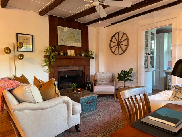a living room with furniture a window and a chandelier