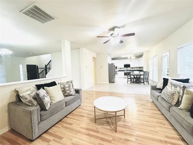 a living room with furniture or couch and a dining table