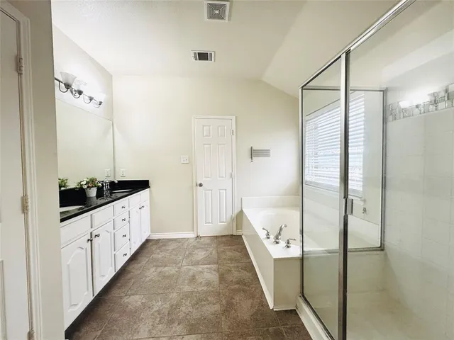 a bathroom with a bathtub and a shower