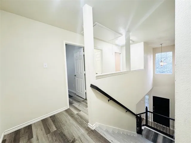 a view of a room with wooden floor and white walls