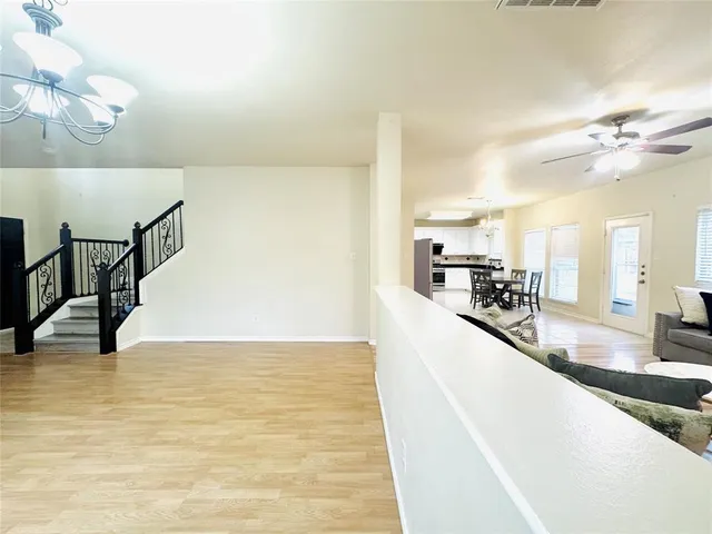 a kitchen with stainless steel appliances kitchen island granite countertop a refrigerator and a stove top oven