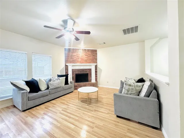 a living room with furniture kitchen view and a table