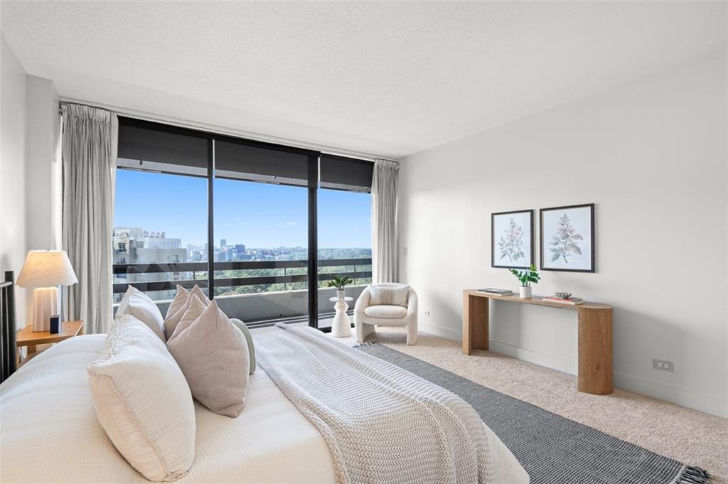 2660 Peachtree Road Northwest, Unit 19A Atlanta, GA 30305 - Photo 17 of 51 a bed room with a bed and a large window