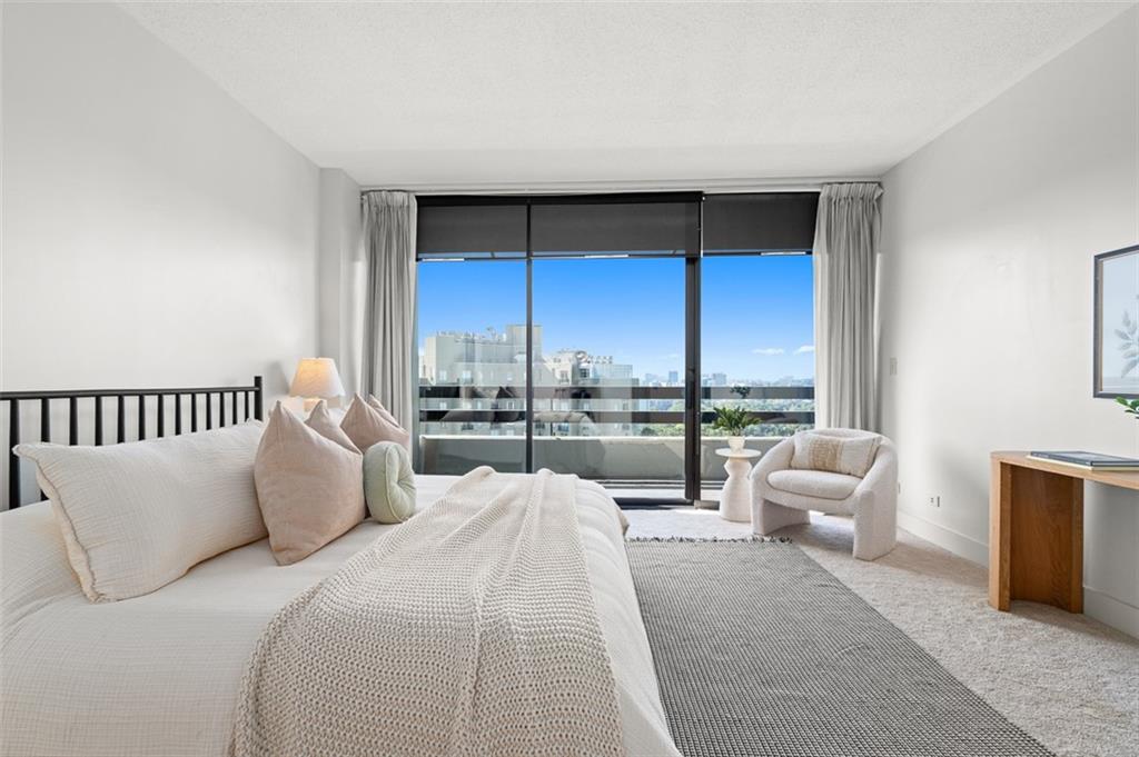 2660 Peachtree Road Northwest, Unit 19A Atlanta, GA 30305 - Photo 18 of 51 a bedroom with a bed and large window