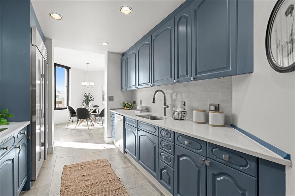2660 Peachtree Road Northwest, Unit 19A Atlanta, GA 30305 - Photo 24 of 51 a kitchen with stainless steel appliances granite countertop a sink stove and cabinets