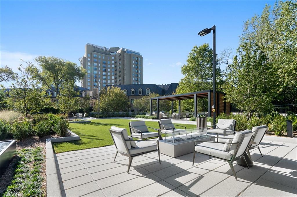2660 Peachtree Road Northwest, Unit 19A Atlanta, GA 30305 - Photo 37 of 51 a view of a patio with couches potted plants and a big yard