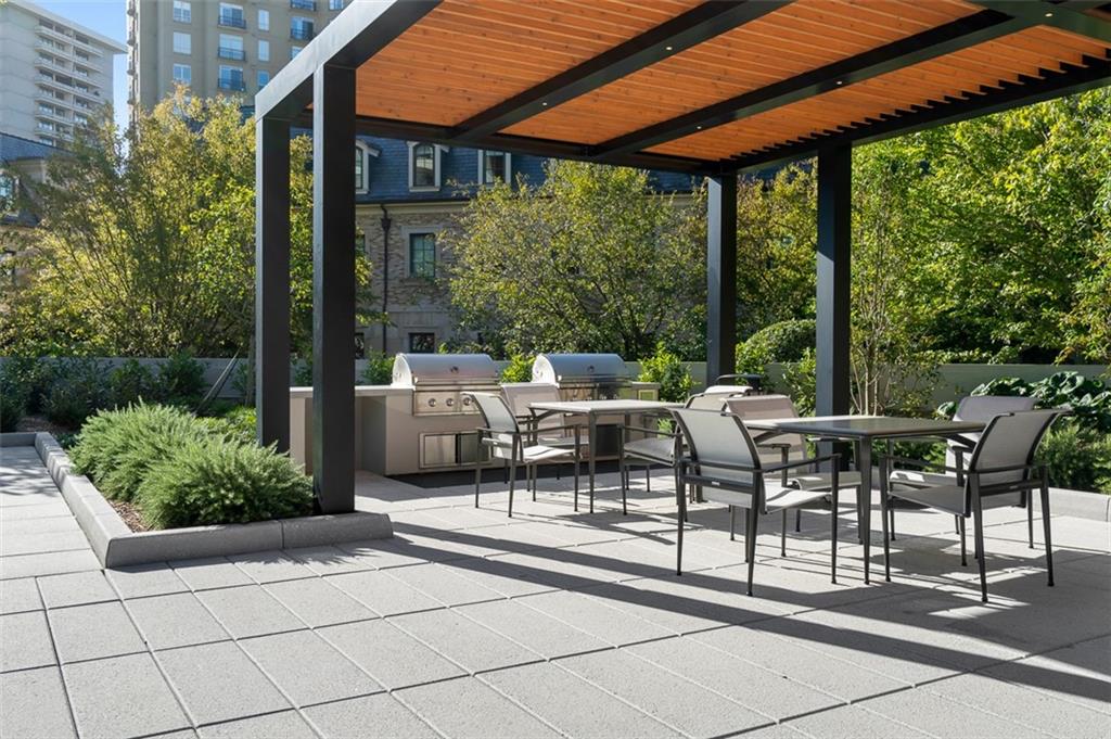 2660 Peachtree Road Northwest, Unit 19A Atlanta, GA 30305 - Photo 39 of 51 a view of a patio with table and chairs and potted plants