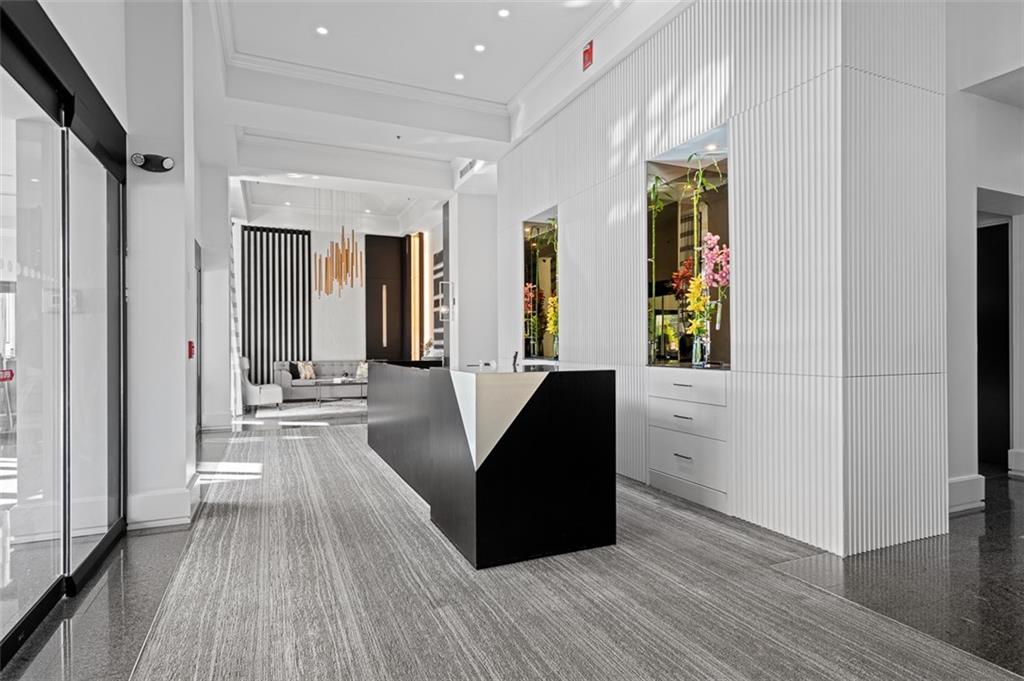 2660 Peachtree Road Northwest, Unit 19A Atlanta, GA 30305 - Photo 48 of 51 a living room with furniture and a wooden floor