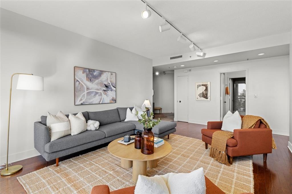 2660 Peachtree Road Northwest, Unit 19A Atlanta, GA 30305 - Photo 9 of 51 a living room with furniture and a wooden floor