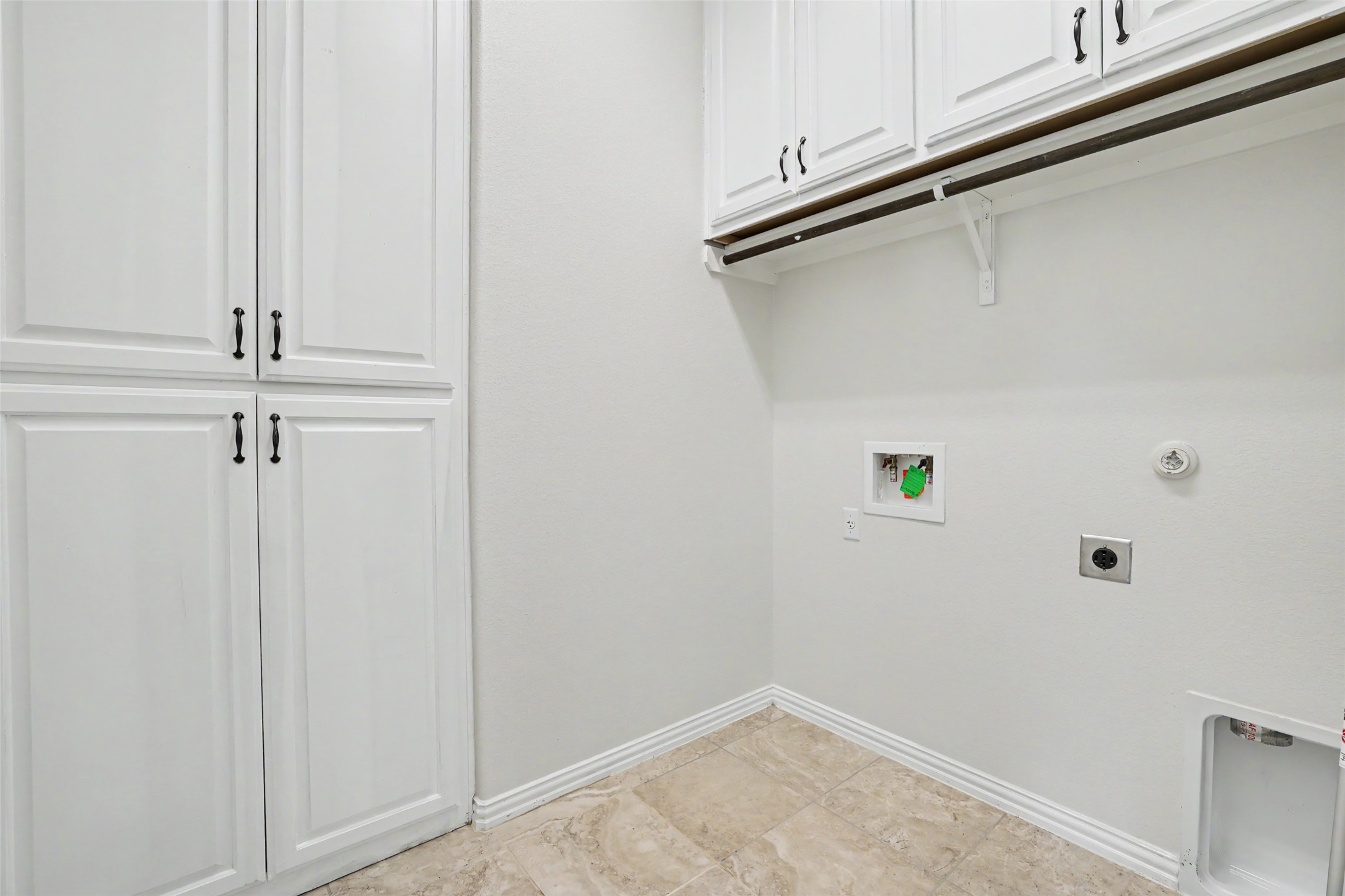 1020 Winding Way Drive Georgetown, TX 78628 - Photo 26 of 32 Laundry area featuring cabinet space, hookup for an electric dryer, and washer hookup