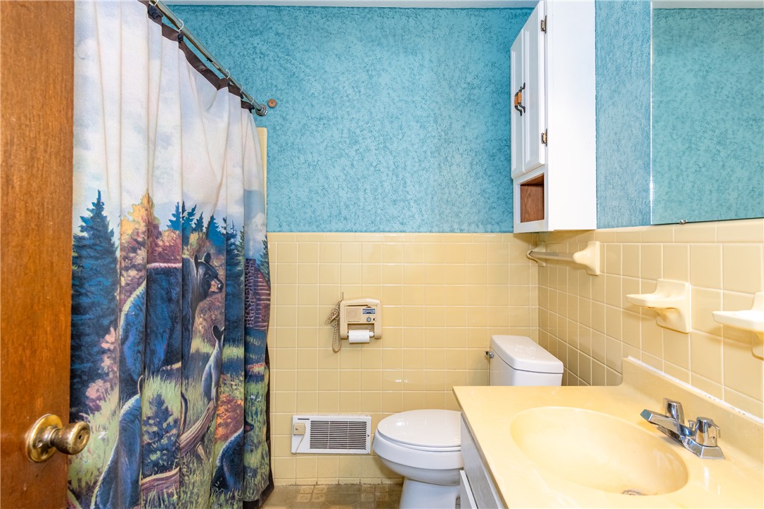 5760 Kitridge Road Dayton, OH 45424 - Photo 11 of 19 This bathroom features a shower, sink, and toilet, offering a practical and comfortable space.