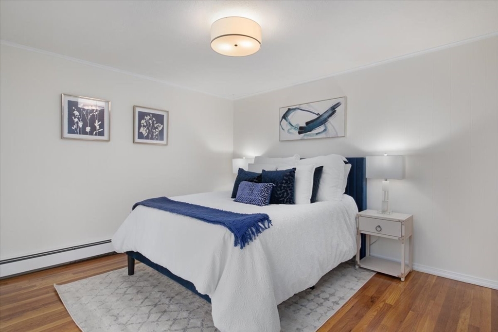 136 Beechnut Road Westwood, MA 02090 - Photo 16 of 42 a bedroom with bed and wooden floor