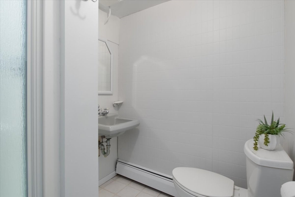 136 Beechnut Road Westwood, MA 02090 - Photo 31 of 42 a bathroom with a sink a toilet and a mirror
