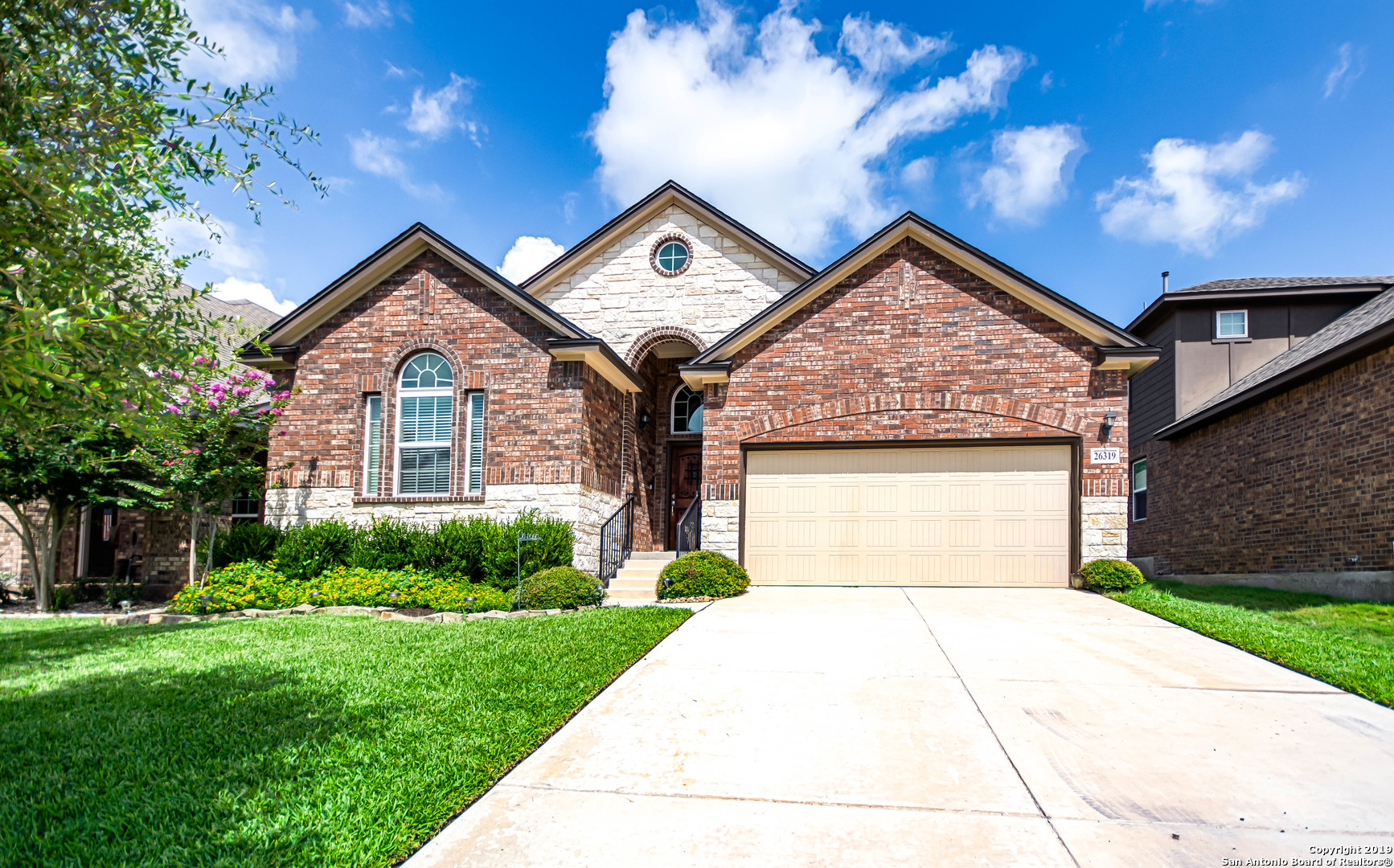 a front view of a house with a yard and garage