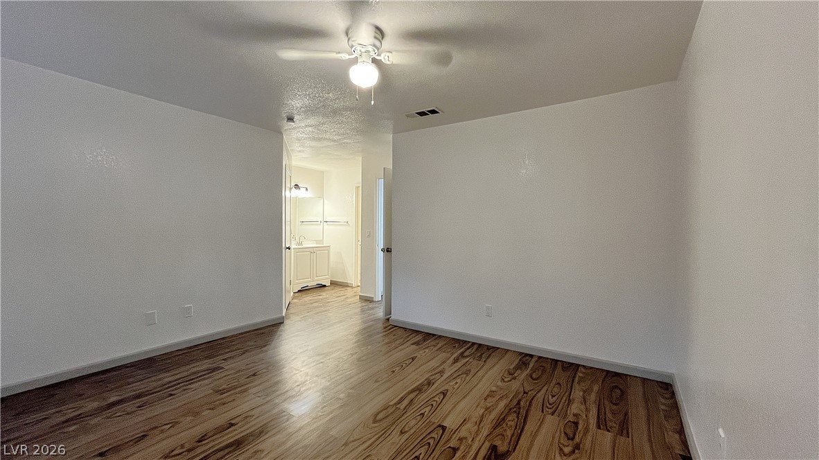 6750 Del Rey Avenue, Unit 123 Las Vegas, NV 89146 - Photo 12 of 21 Rich hardwood-style flooring extends through this generously proportioned living area.